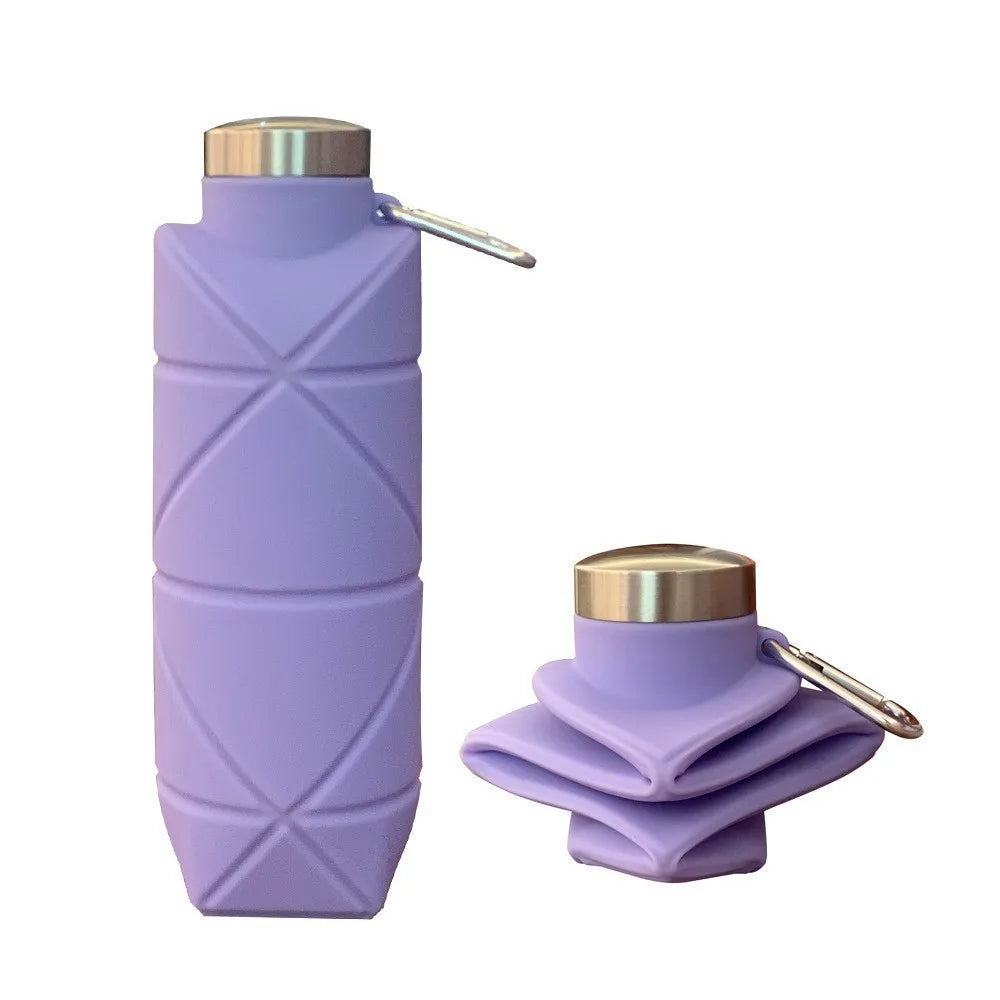 Collapsible silicone water bottle folded flat next to an expanded bottle for travel