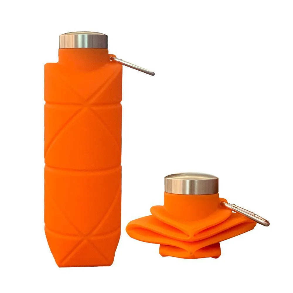Collapsible silicone water bottle folded flat next to an expanded bottle for travel